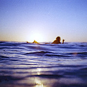 Surfer in the evening light with hang loose A surfer in the warm evening light after a fulfilling surf session – the perfect end to a day of surf lessons in Fuerteventura.