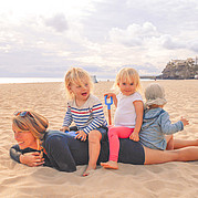 Family with kids on the beach of Morro Jable