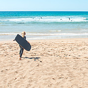 Boogie boarding under supervision while parents are at surf lessons
