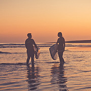 SUP surfers on our house beach at sunset