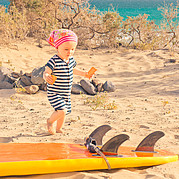 Toddler discovers surfboard