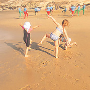 Children watch surfing lessons