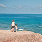 Family with small children on the surf beach